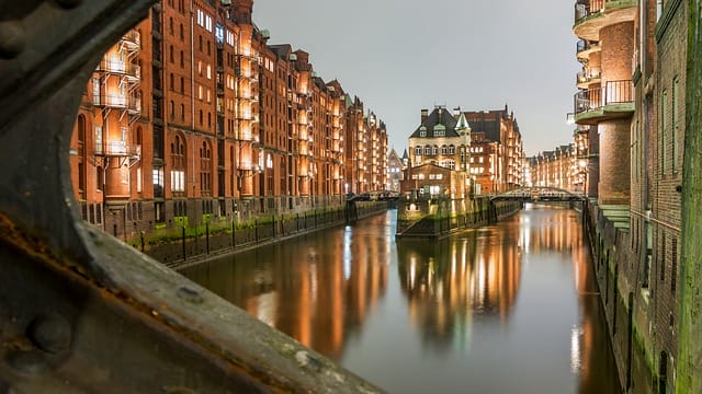 "Funding for new build real estate in Frankfurt and Hamburg" - The famous Wasserschloss in Hamburg's Speicherstadt, an area experiencing rapid real estate development.