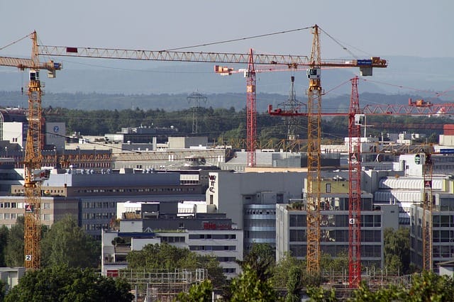 Aerial shot of cranes over the Zurich skyline. Here, and in German cities, new categories are being developed that help determine property values in a rapidly changing real estate market.