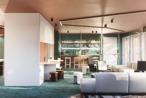 Modern eingerichtete Wohnzimmer-Lounge mit Küche im Hintergrund als Gemeinschaftsfläche im Neubauprojekt Van B.